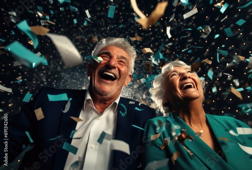 an elderly couple laughing, hugging and bouncing confetti