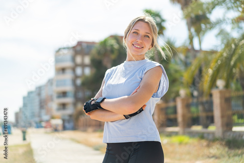 Young blonde woman at outdoors wearing sport wear