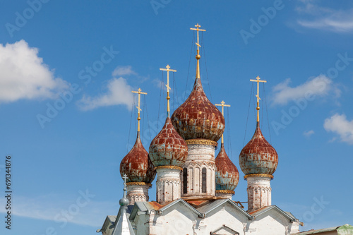 Picturesque domes of an old Orthodox church against a background of blue sky and white clouds