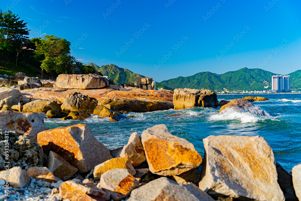 Rocky seashore.

A sea wave is beating against the rocks near the seashore. Filmed at sunset near the rock garden in Nha Trang, Vietnam.