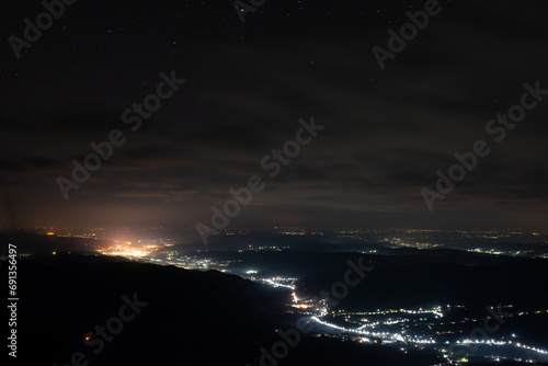 City lights seen from above. Light pollution covering the night sky. Amazing view with the artificial lights observed from a high point