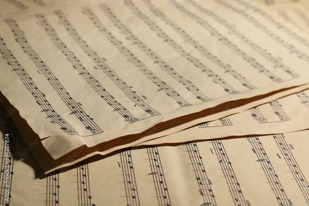 Naklejka premium Many old note sheets as background, closeup