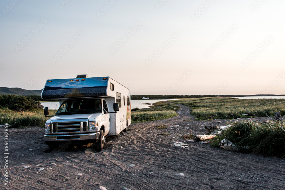 Camper RV truck parked at the Cape Breton Island Coast line Sunset cliff scenic Cabot Trail Nova Scotia Hghlands Canada