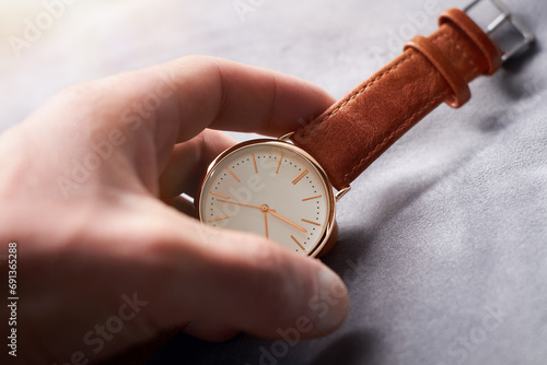 A leather watch in the hands of a man. Close-up business concept
