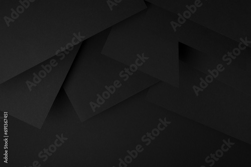 Exquisite black background with abstract geometric pattern of corners, angles, flat shapes, triangles as relief in graphic style, border, for text, sale, advertising, card, flyer, poster.