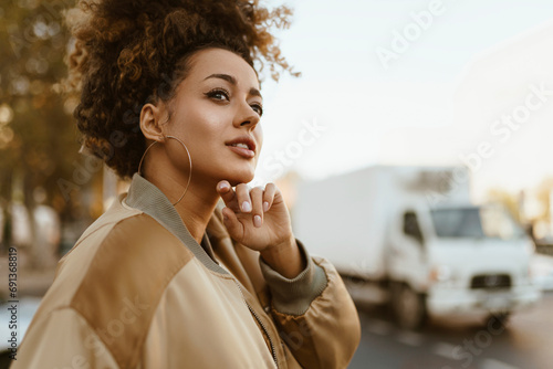 Smiling young woman with hand on chin photo