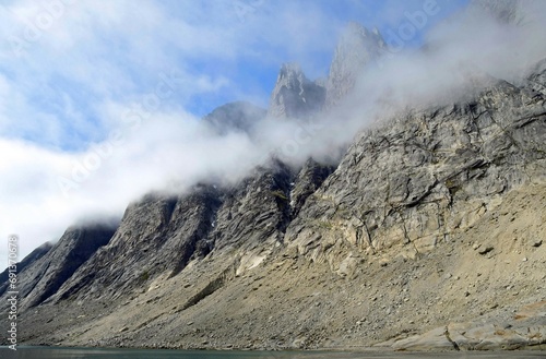steep, jagged peaks adjacent to the sermeq glacier at the end of the tasermuit fjord on a sunny summer day near nanortalik, in southern greenland