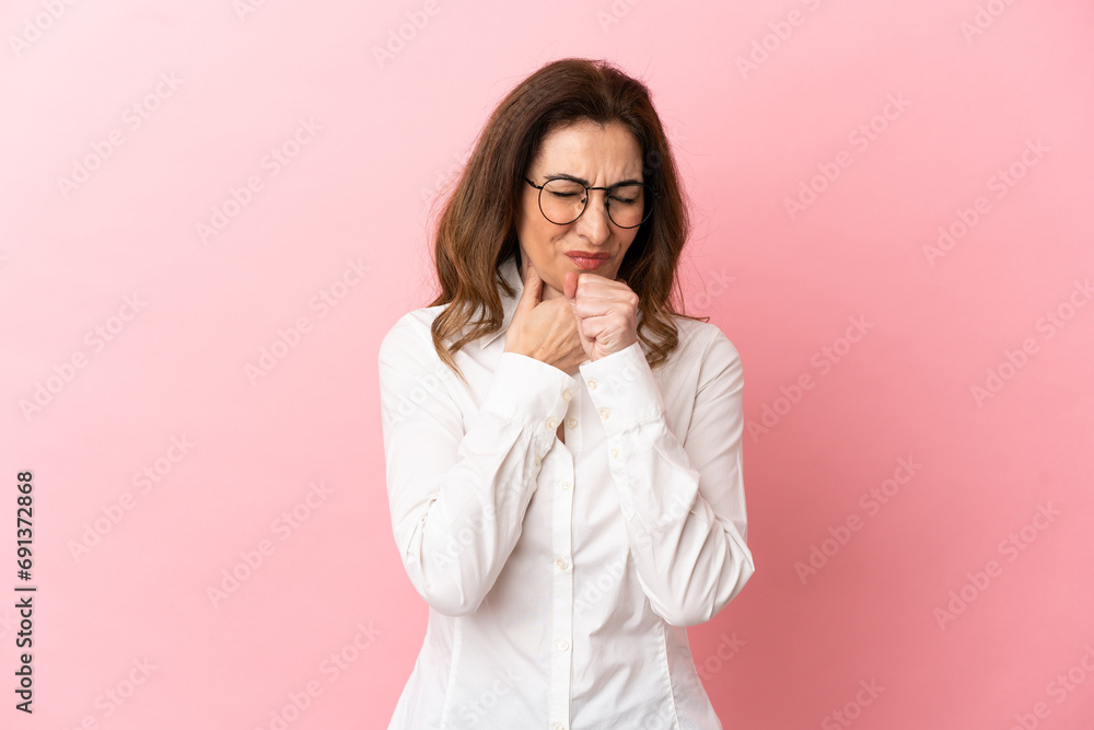 Middle aged caucasian woman isolated on pink background coughing a lot Middle aged caucasian woman isolated on pink background coughing a lot