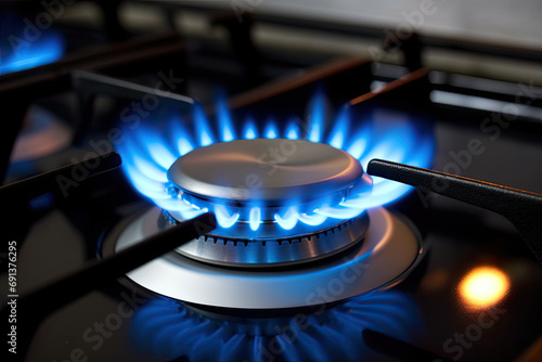 Close up shot of blue fire from domestic kitchen stove top. Gas cooker with burning flames of propane gas. Gas supply chain and news. Global gas crisis and price rise