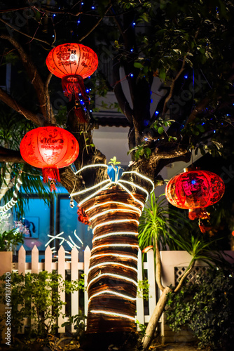 Many red lanterns with vietnamese language translated as "Happy New Year" hanging in Vietnam for Tet Lunar New Year