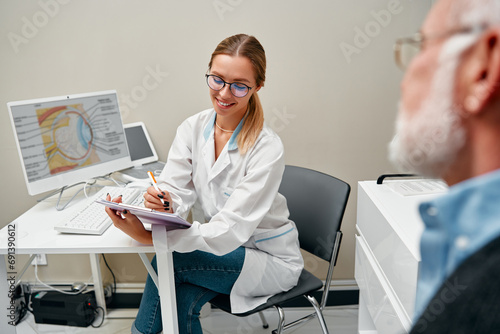 Glasses fitting and eye examination by an ophthalmologist photo