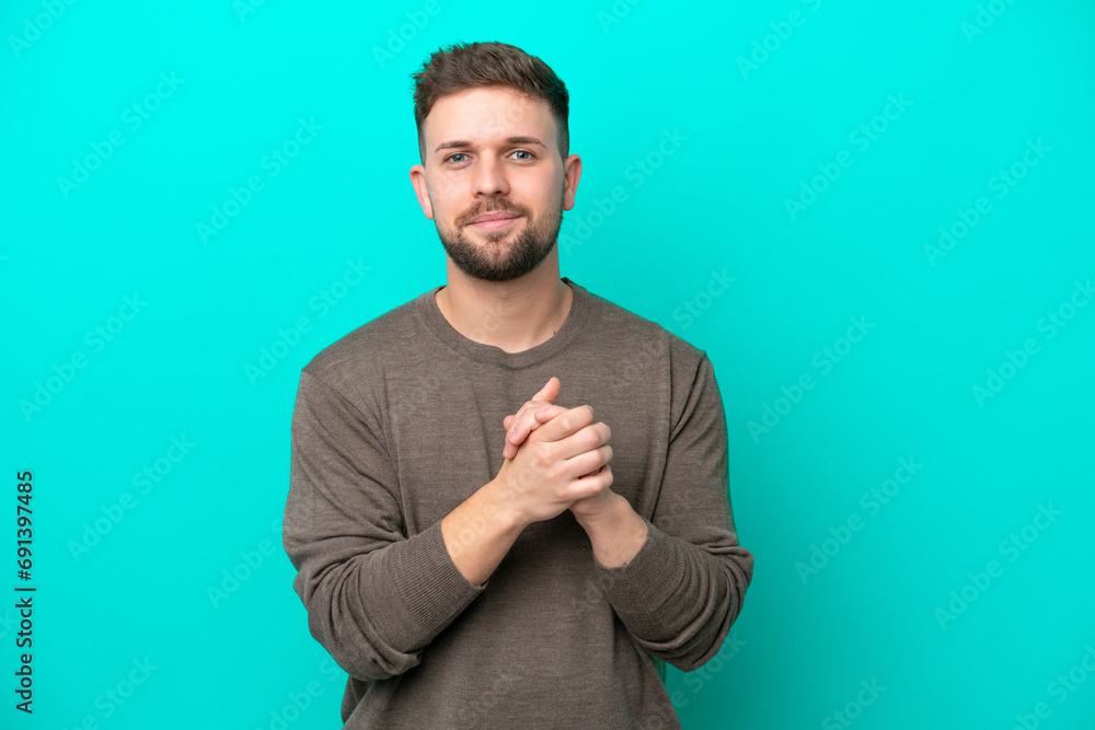Young caucasian man isolated on blue background laughing Young caucasian man isolated on blue background laughing