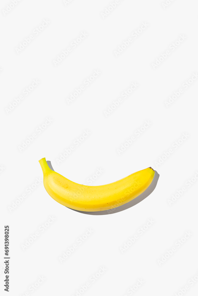 Minimalistic banana on white isolated background. Creative concept of smile.