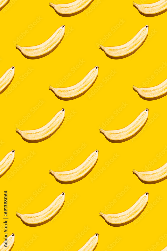 Seamless pattern of bananas on yellow background.
