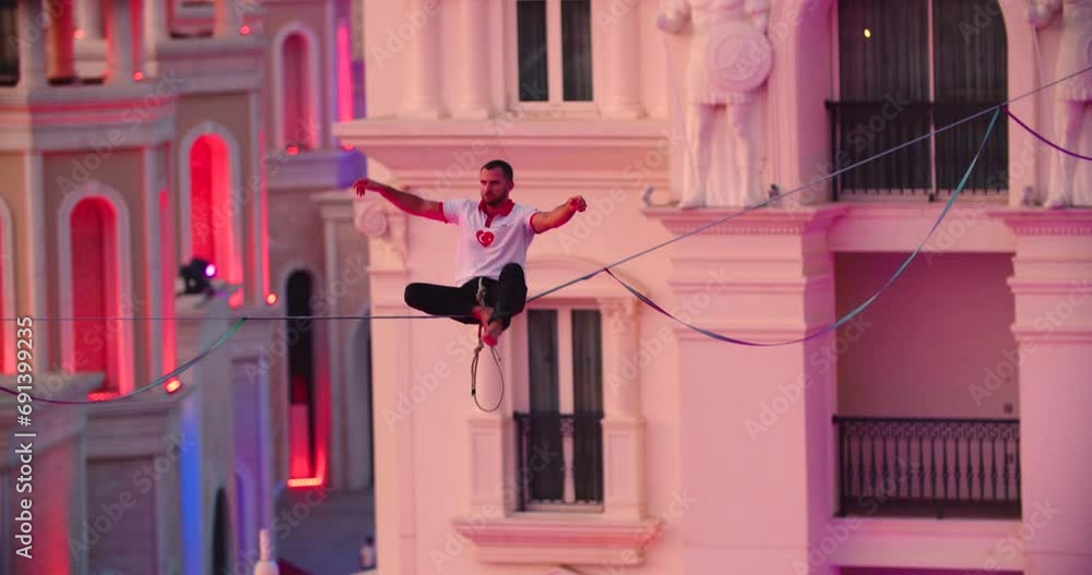Incredible balance of a man sitting on the slackline high up, Antalya, Turkey 4k