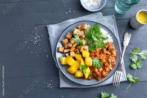 Exotic salad bowl with mango tofu and nuts