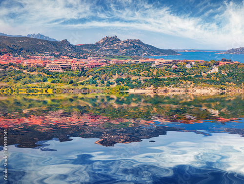 Palau town with Sciumara beach reflected in the calm waters of Mediterranean sea, Province of Olbia-Tempio, Italy, Europe. Calm summer view of Sardinia island. Vacation concept background.. photo