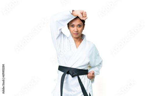 Young Uruguayan woman over isolated chroma key background doing karate