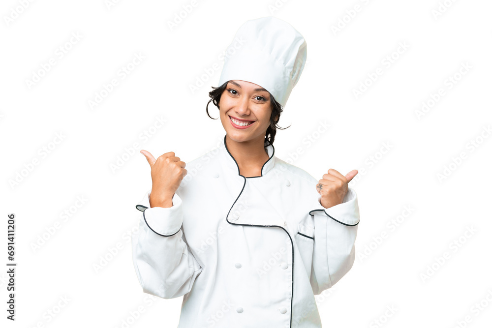 Young chef Argentinian woman over isolated background with thumbs up gesture and smiling Young chef Argentinian woman over isolated background with thumbs up gesture and smiling