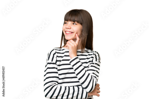 Little caucasian girl over isolated background thinking an idea while looking up