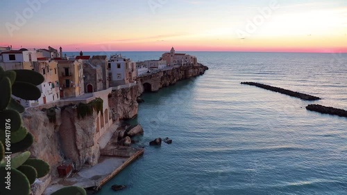 Awesome evening cityscape of Vieste - coastal town in Gargano National Park, Italy, Europe. Captivating spring sunset on Adriatic sea. Full HD video (High Definition).. photo