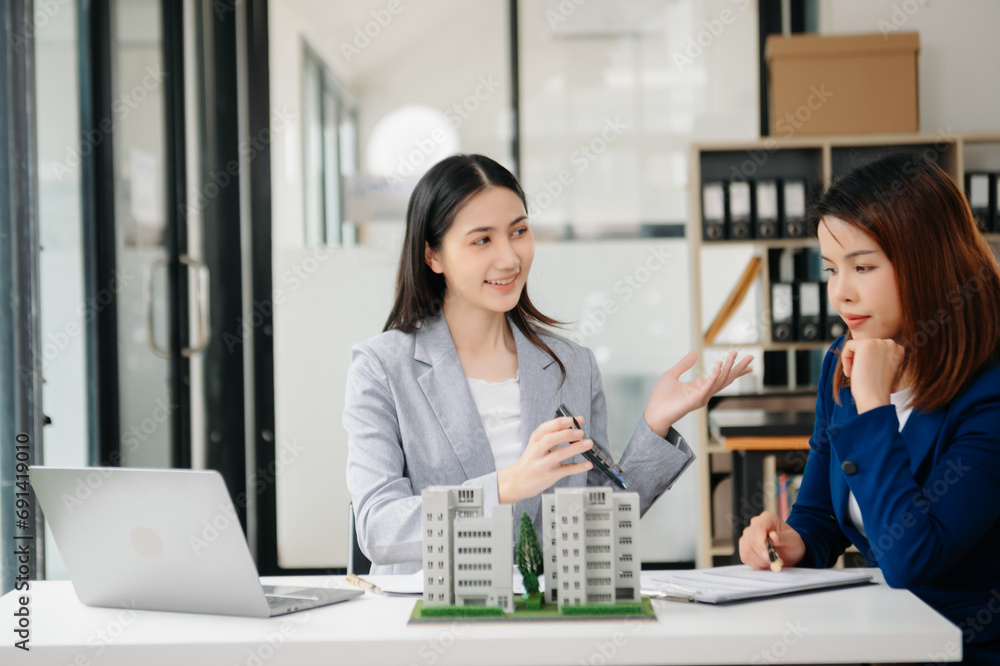 Fototapeta premium Customers who choose to buy a condominium room and a bank approve a loan for their purchase. Condominium and house loan interest rate from bank