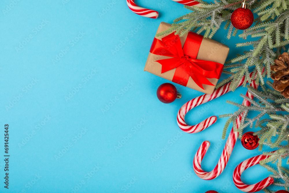 Christmas candy.Candy cane.Christmas composition with gifts, Christmas tree decorations on a blue background. Concept for Christmas and New Year holidays. Winter. Flatlay, top view, copy space.