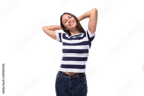 close-up of a young brunette woman model dressed in a striped t-shirt and jeans. people lifestyle concept