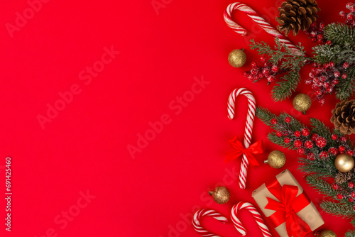 Christmas candy canes on a red background. Holiday greeting card. Concept for Christmas and New Year holidays. Winter. Flatlay  top view  copy space.