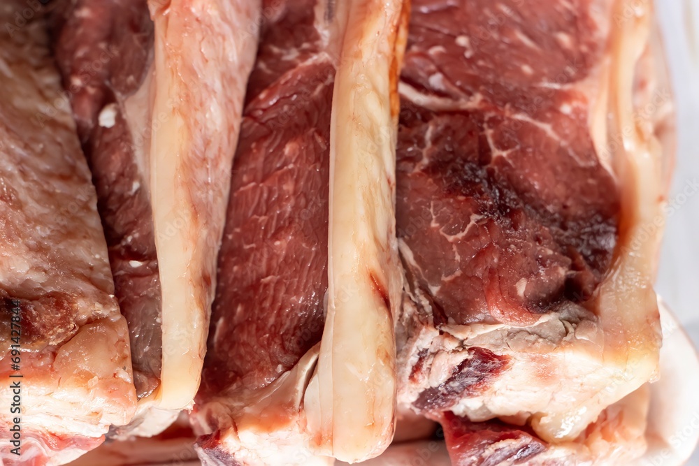 close up of a tray of raw ribeye meat prepared for cooking