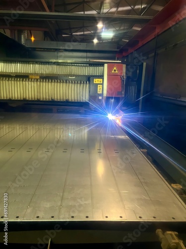 Vertical view of laser cutting. Metal machining with sparks on CNC maching