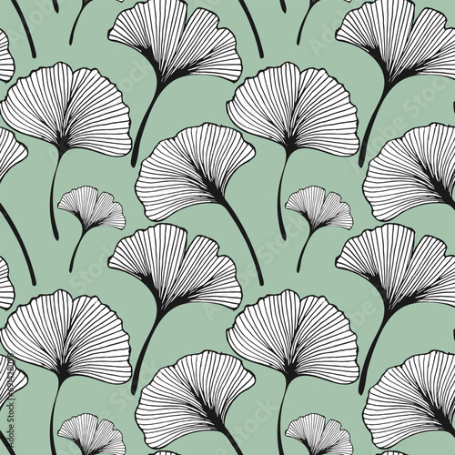 Seamless pattern  hand drawn ginkgo biloba leaves on a green background. Background  print  elegant textile  vector