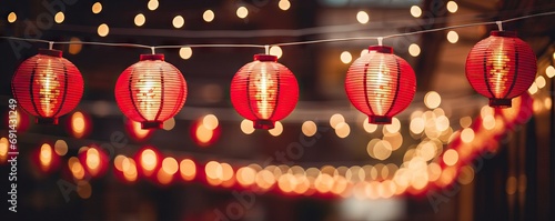 Red hanging lantern traditional Asian decor on blurred night street. Chinese lantern festival. New Year abstract greeting background with copy space. Design for poster, card, banner	 photo