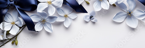 Flowers and silk navy ribbon on white panoramic background. Flat lay top view composition with copy space for banner card wedding photo
