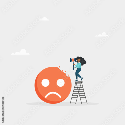 Concept of overcoming stress and negative influence. Stress resistance, victory over depression. The girl hits a sledgehammer with a negative emoticon.
