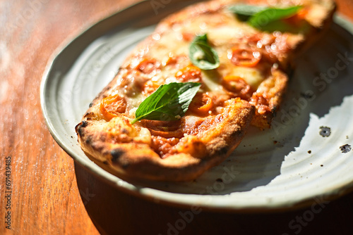 Sliced and served Italian pizza Margherita with basil leaves