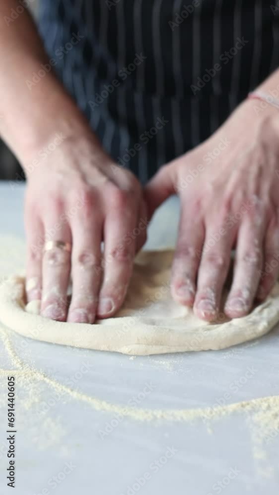 Chef shapes pizza dough with his hands Chef shapes pizza dough with his hands
