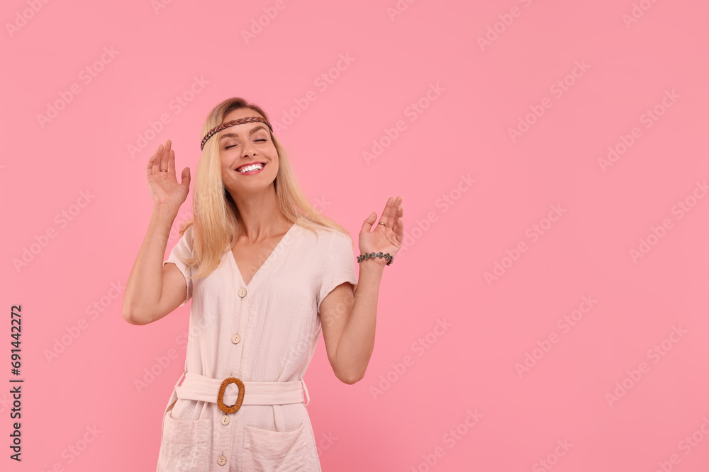 Portrait of happy hippie woman on pink background. Space for text Portrait of happy hippie woman on pink background. Space for text