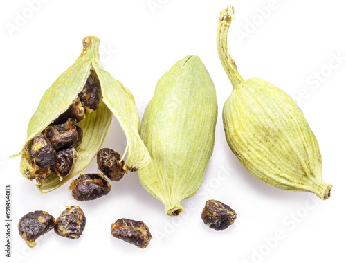 Green cardamom pods and seeds isolated on white background.