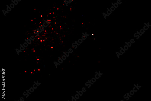 Red blurred bokeh lights on black background. Glitter sparkle confetti for celebrate. Overlay for your design