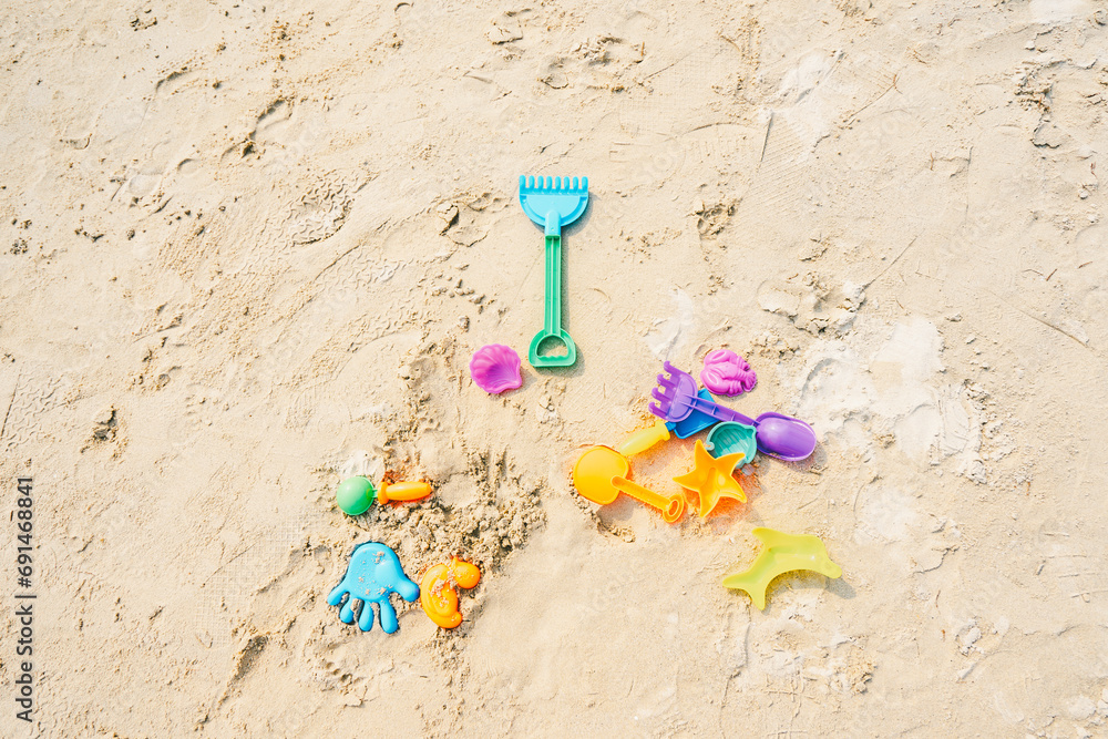 Colored plastic toy on sand beaches, summer season. Toy for babies and toddlers to joyfully learn mechanical skills and colors. Colored plastic toy on sand beaches, summer season. Toy for babies and toddlers to joyfully learn mechanical skills and colors.