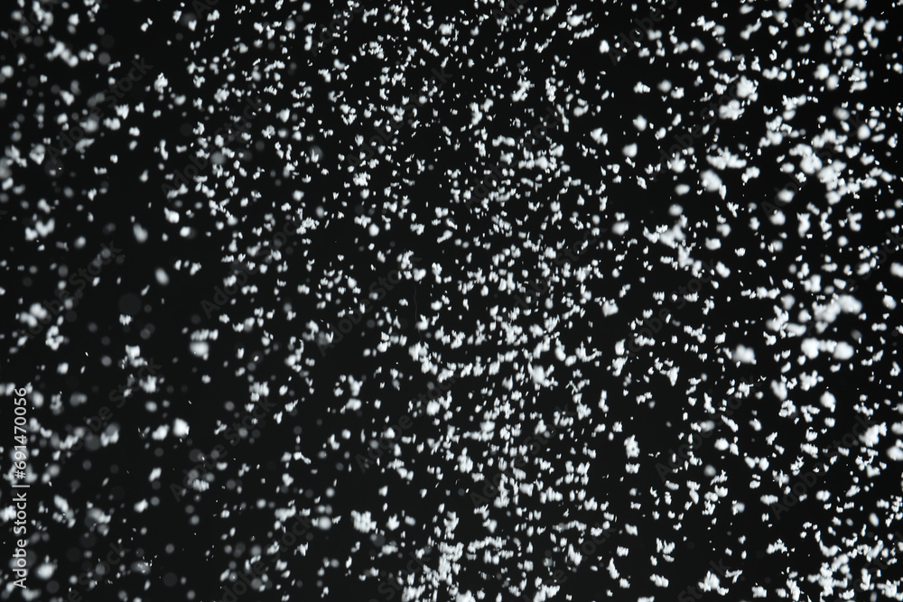 White snow falling down on black background White snow falling down on black background