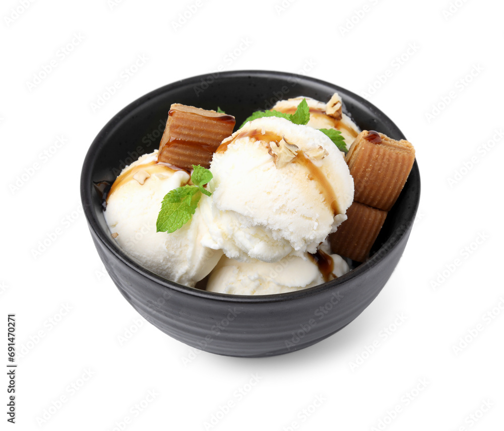 Tasty ice cream with caramel sauce, mint, candies and nuts in bowl isolated on white Tasty ice cream with caramel sauce, mint, candies and nuts in bowl isolated on white