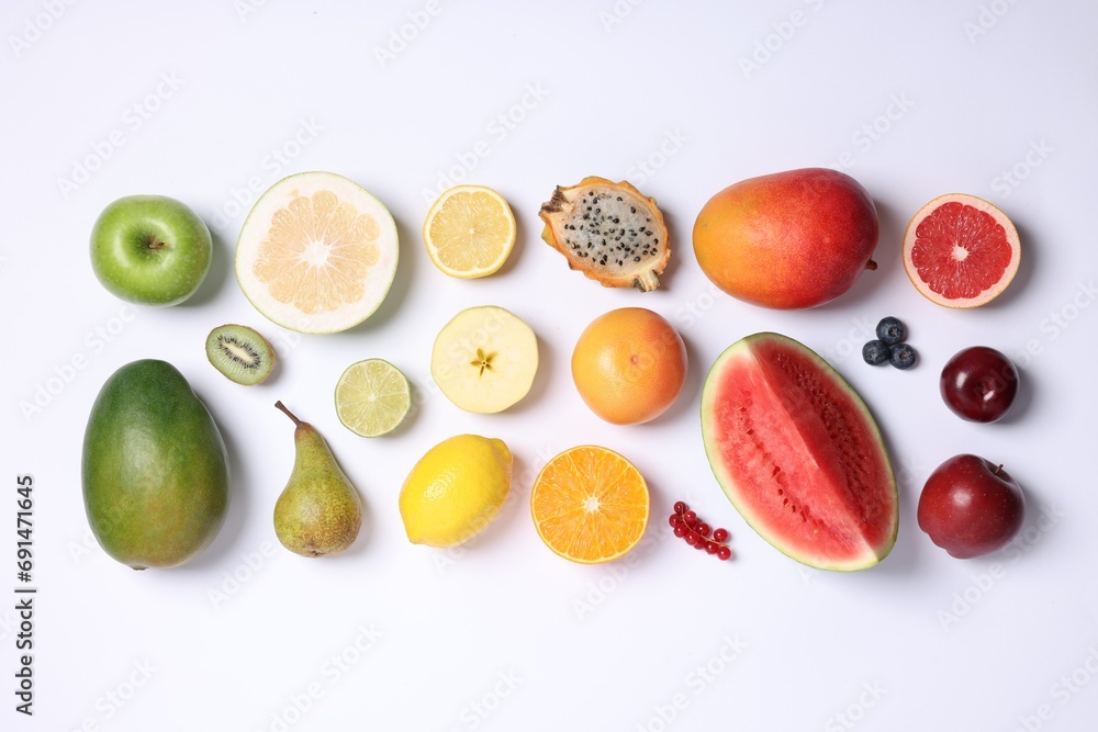 Different ripe fruits and berries on white background, top view