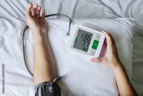 Directly above view of a person performing blood pressure measurement at home.