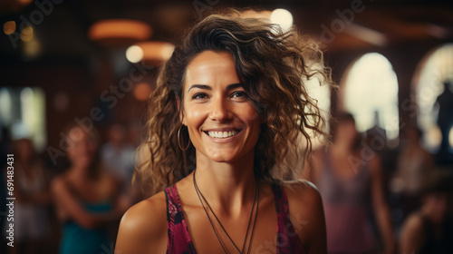 Dance or gymnastics teacher in classes with her students. Woman smiling happy in a zumba class. Young latin woman in the gym. Background with copy space. © Acento Creativo
