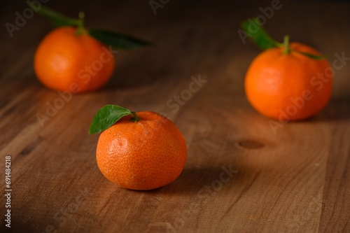 fresh juicy three tangerines on a wooden table 4