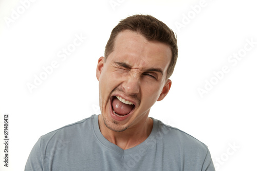 portrait of young happy man winking looking at the camera on white background