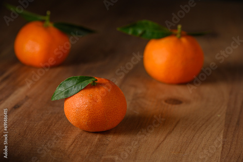 fresh juicy three tangerines on a wooden table 8