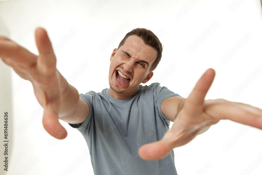portrait of young happy man winking looking at the camera on white background portrait of young happy man winking looking at the camera on white background